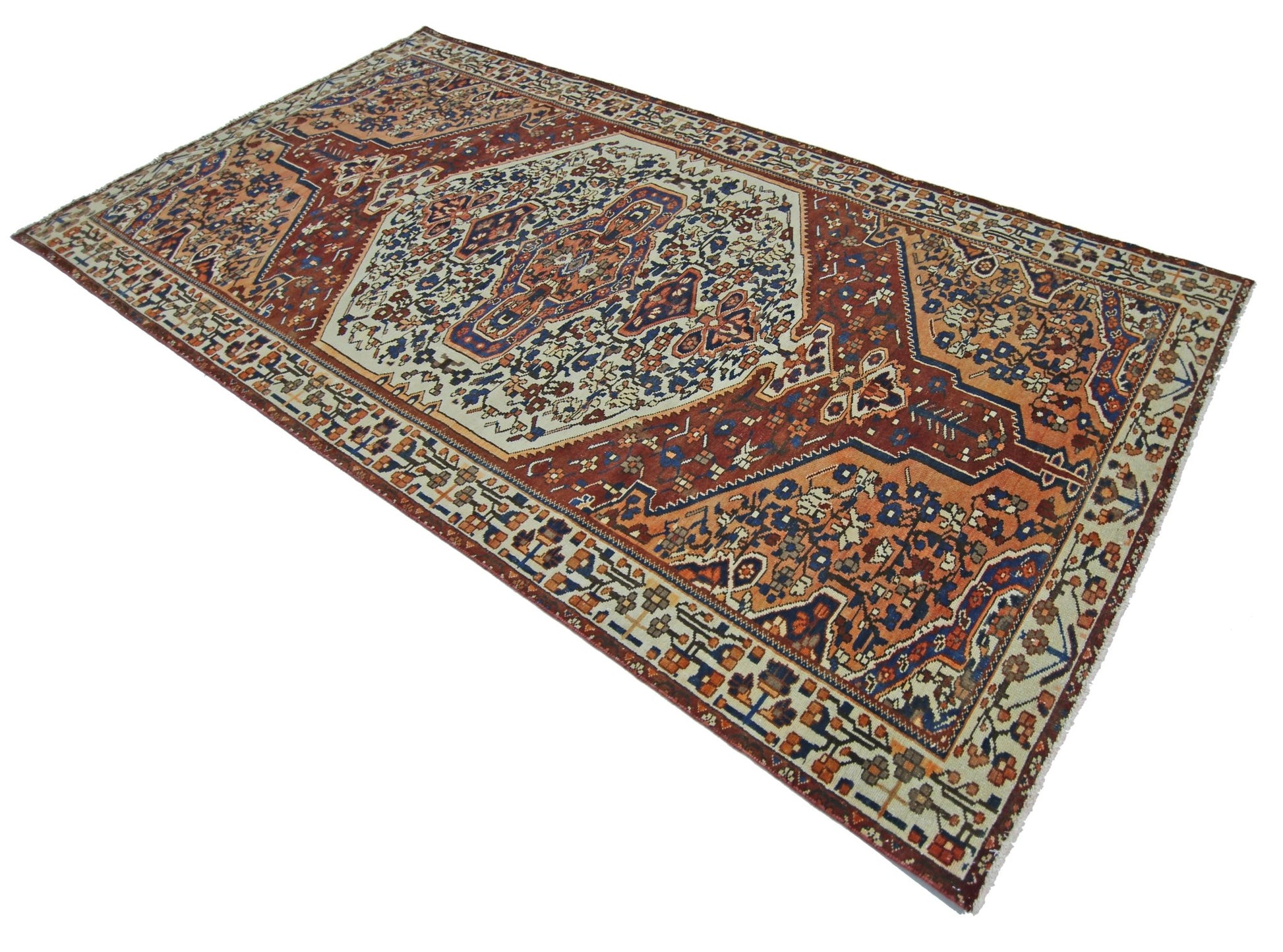 A vintage Persian Bakhtiari rug featuring a central medallion on a rust and cream floral field.