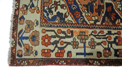 A close-up of a vintage Persian Bakhtiari rug featuring intricate floral patterns in wool.