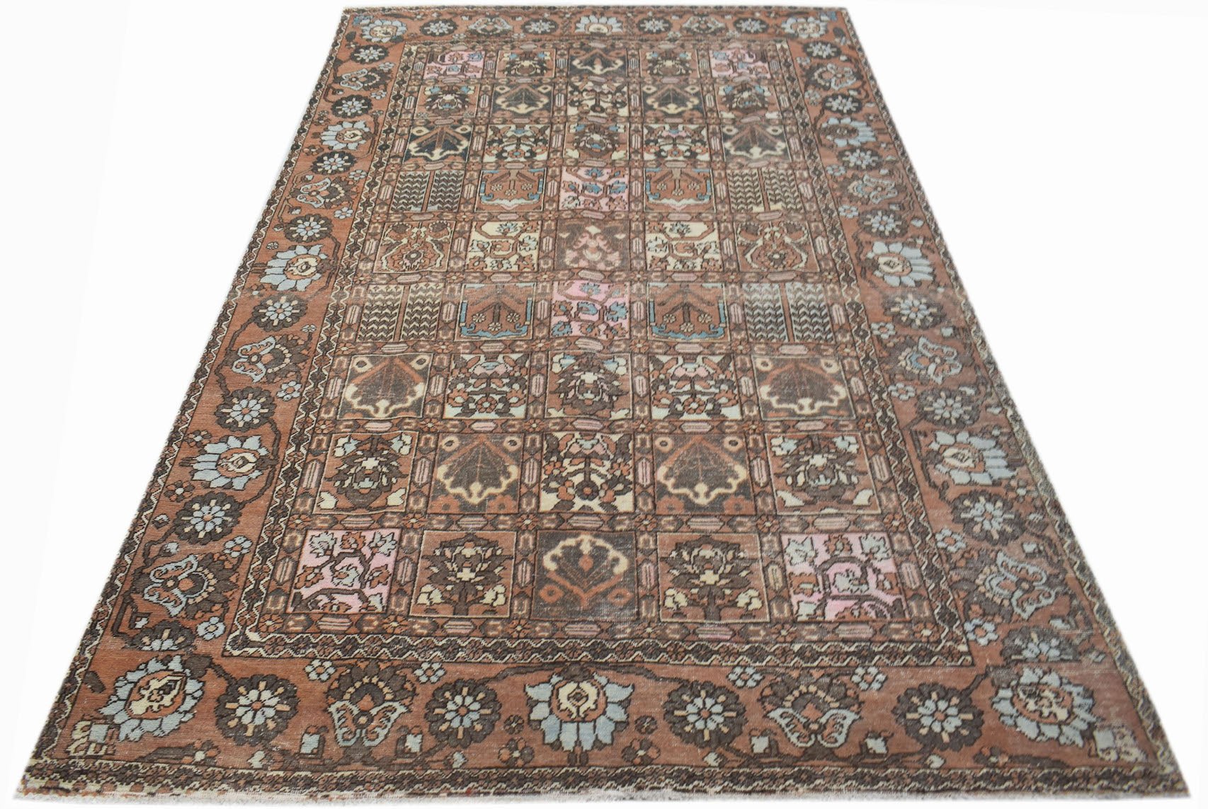 A vintage Persian Bakhtiari rug featuring a multi-colored grid pattern on a terracotta background.