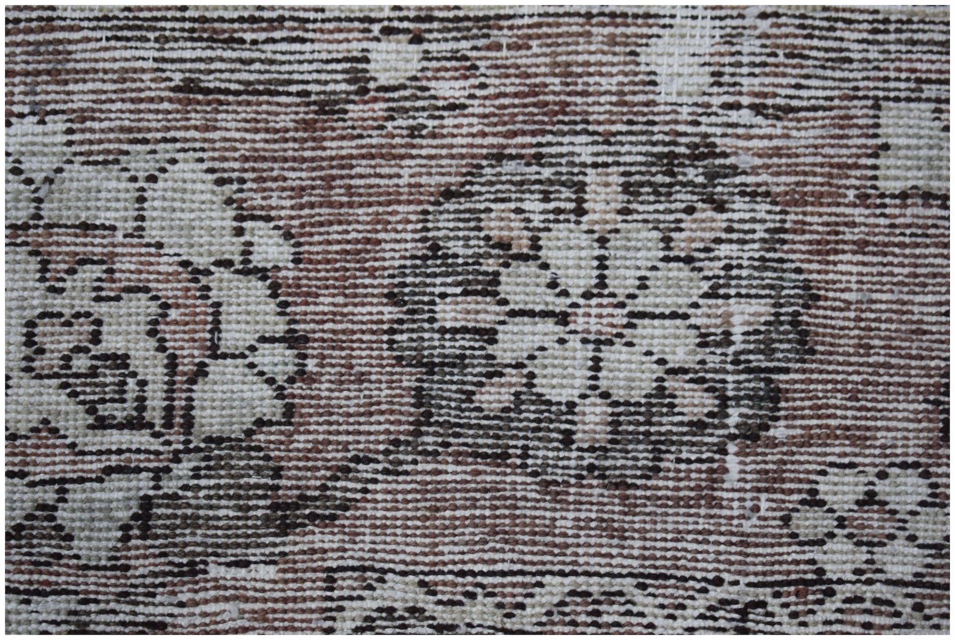 A vintage Persian Bakhtiari rug featuring intricate floral patterns in muted earth tones.