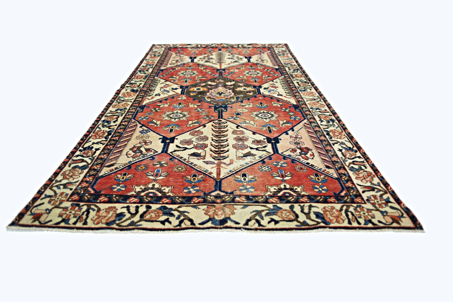 A vintage Persian Bakhtiari rug featuring a geometric diamond pattern in red, blue, and cream.