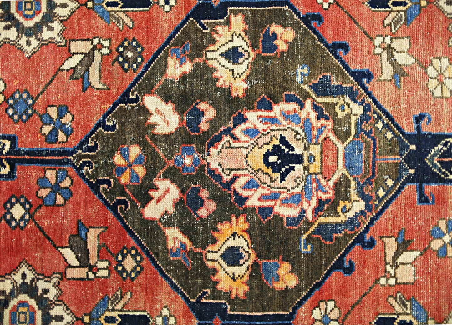 A vintage Persian Bakhtiari rug featuring a dark central medallion with intricate floral motifs.