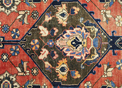 A vintage Persian Bakhtiari rug featuring a dark central medallion with intricate floral motifs.