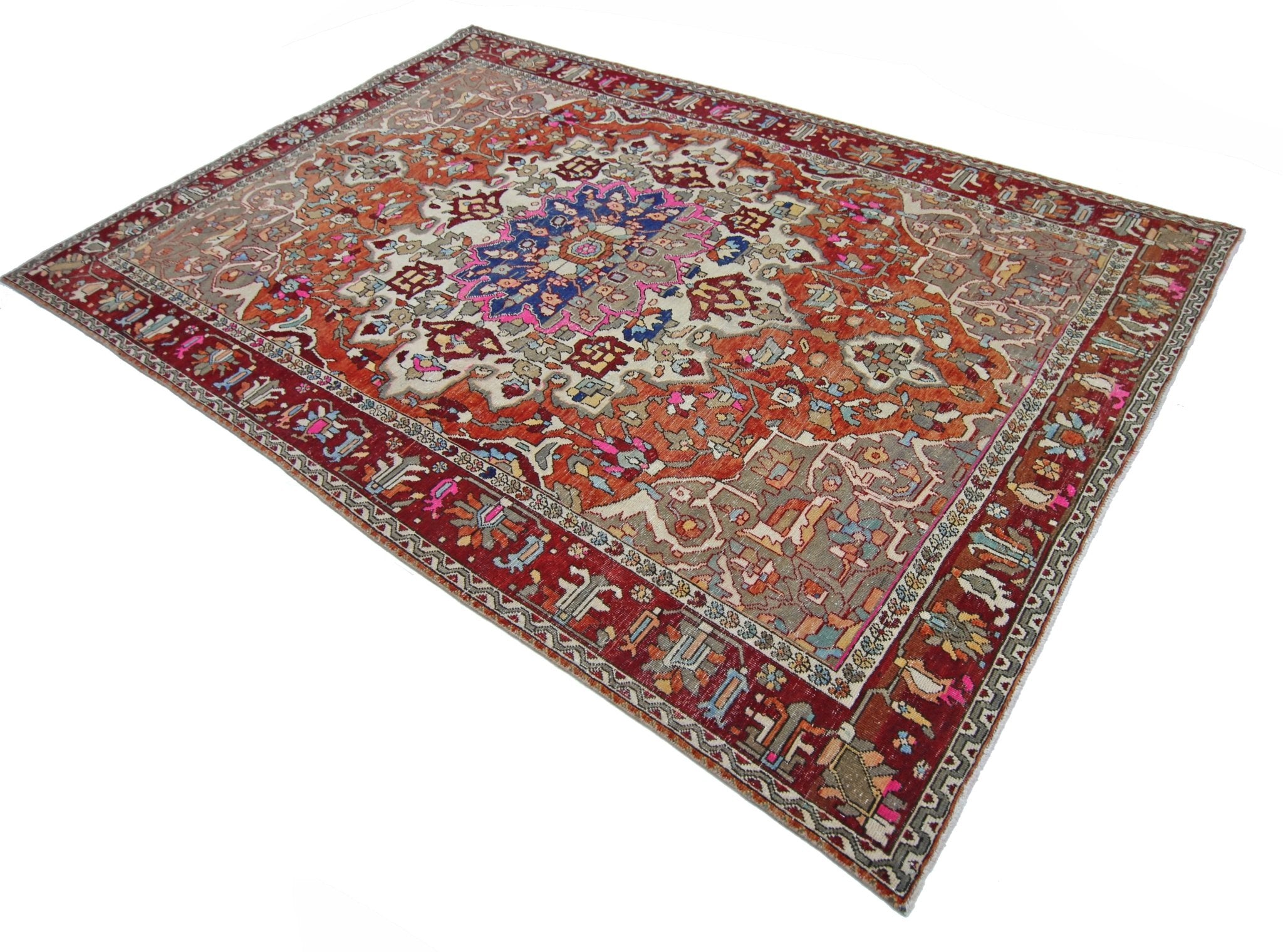A vintage Persian Tabriz rug featuring a central floral medallion on a rust and cream field.