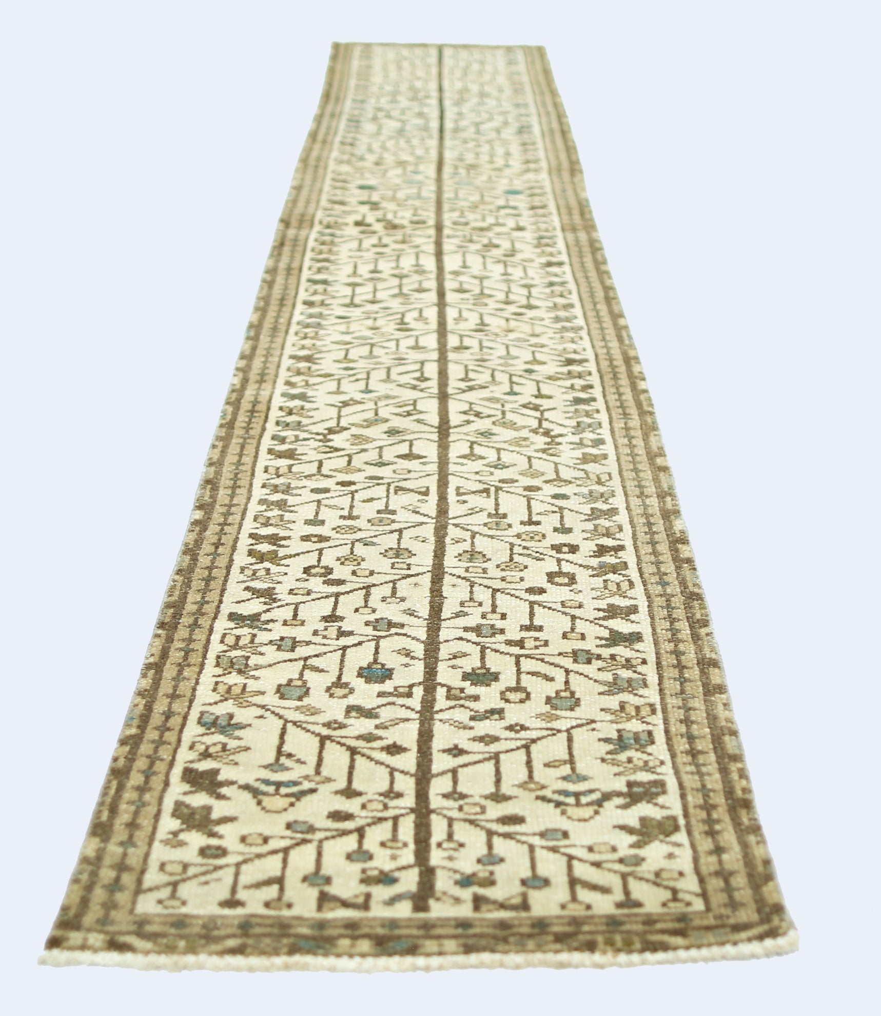 A vintage Persian Bakhtiari runner featuring a central tree motif in neutral tones.