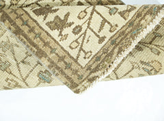 A folded vintage Persian Bakhtiari runner featuring a beige wool pattern on a cotton base.