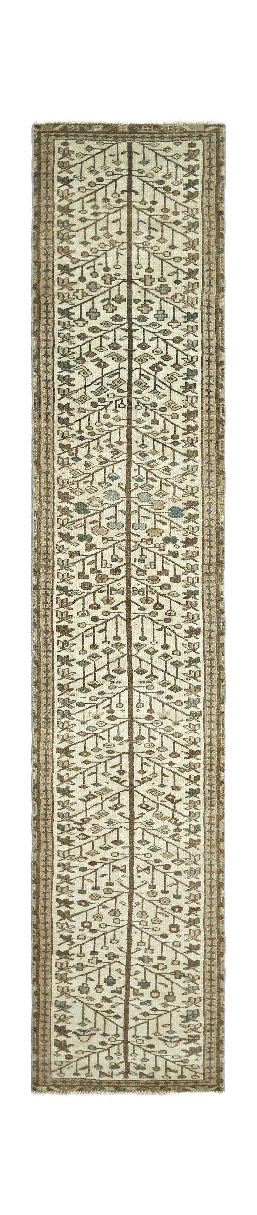 A vintage Persian Bakhtiari runner featuring a central tree of life motif on a cream field.