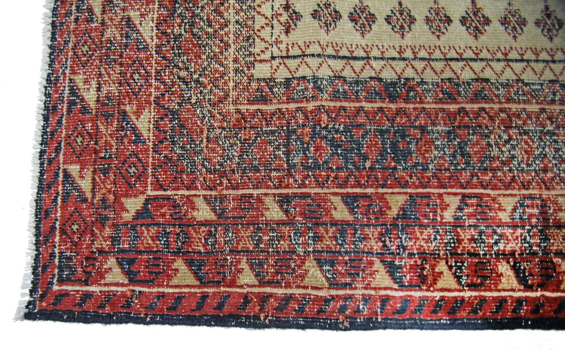 A vintage Persian Bakhtiari runner featuring intricate geometric patterns in red, blue, and cream.