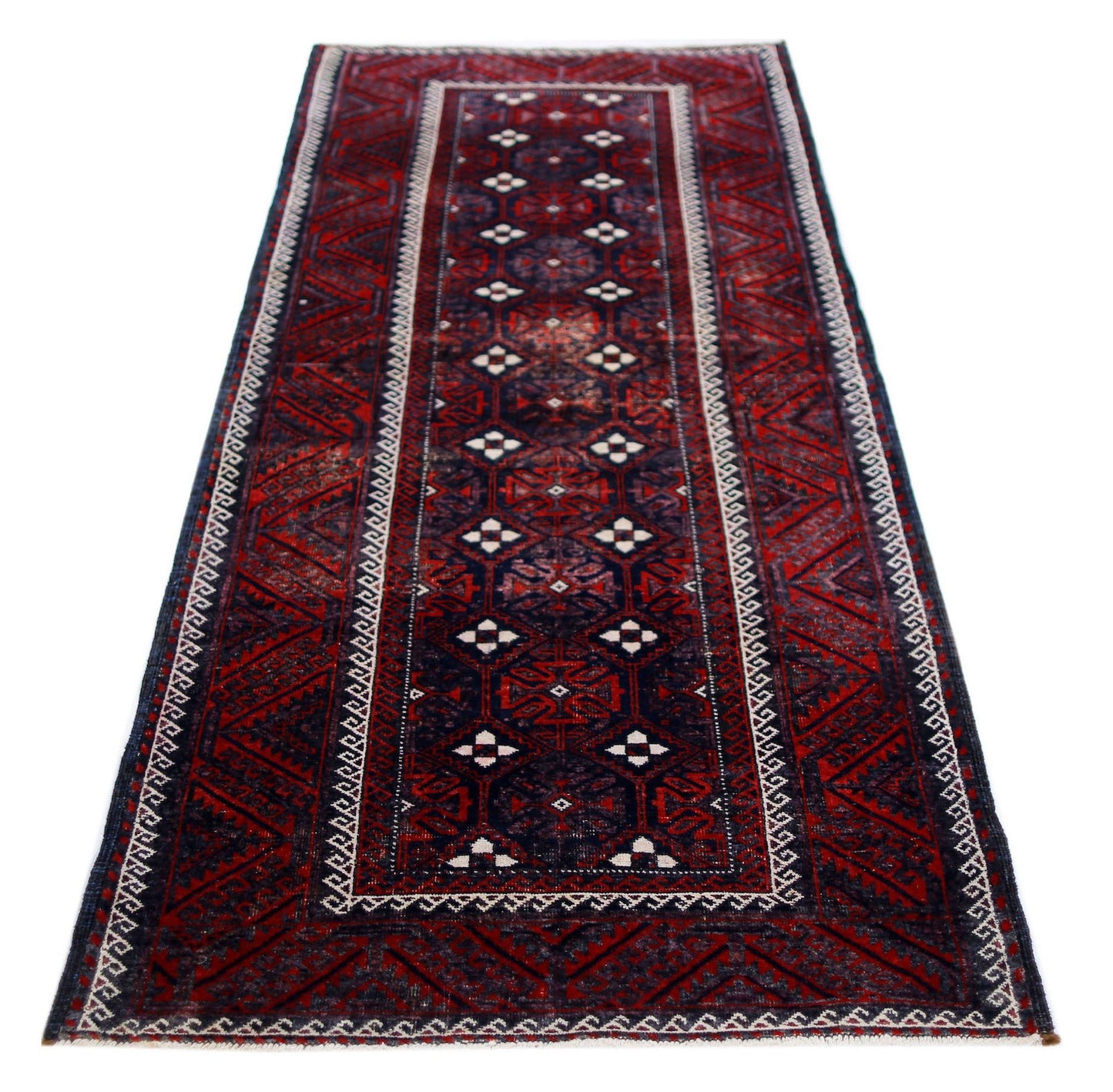 A handmade vintage Afghan Baluch runner rug featuring geometric patterns in deep red and navy blue.