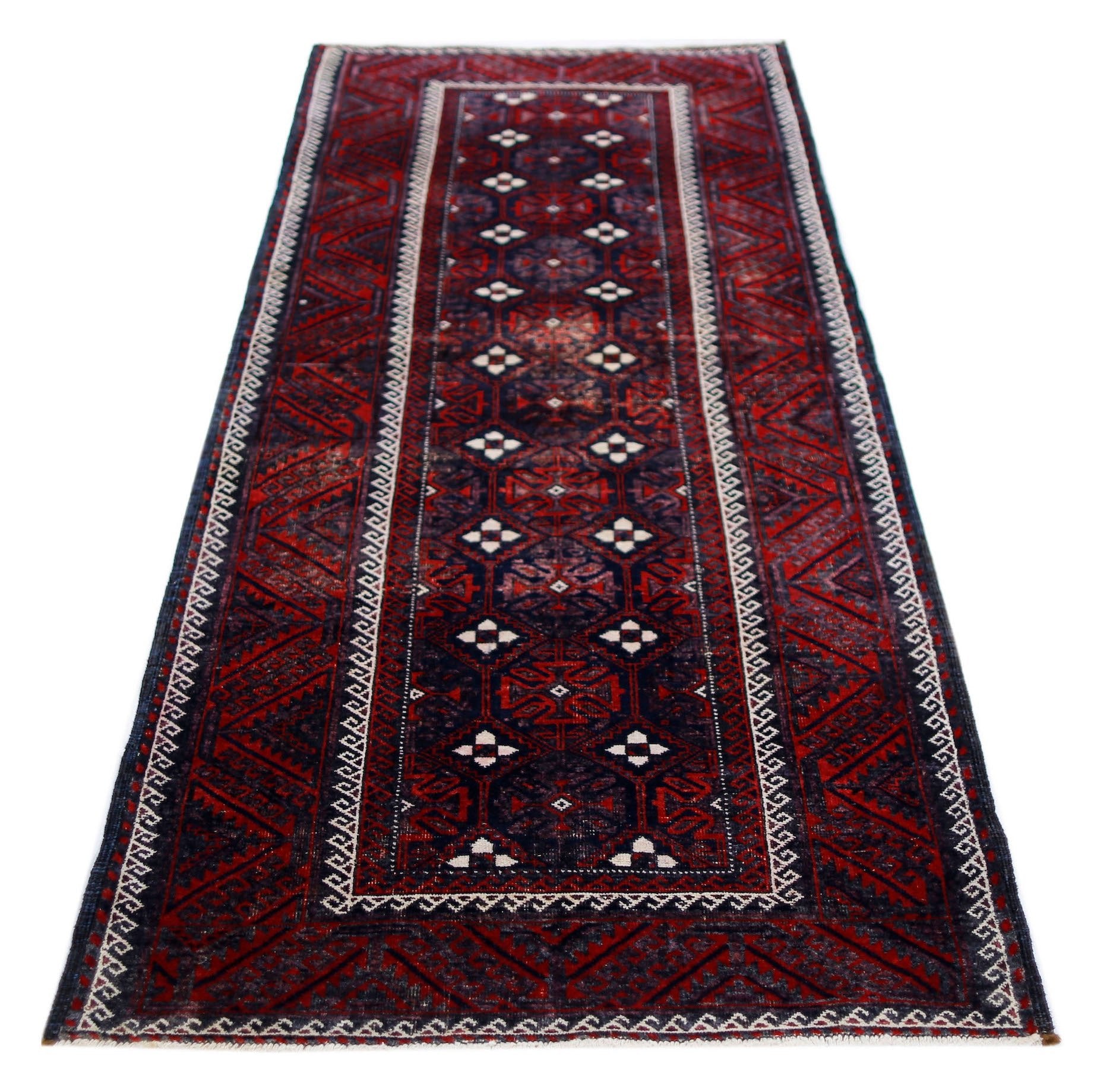 A handmade vintage Afghan Baluch runner rug featuring geometric patterns in deep red and navy blue.