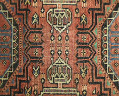 A vintage Persian Baluch runner featuring intricate geometric patterns in red, black, and blue.