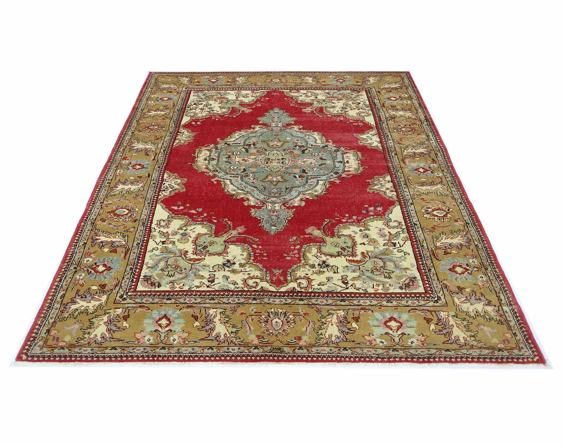 A vintage Persian Bidjar rug featuring a central blue medallion on a red field with floral borders.