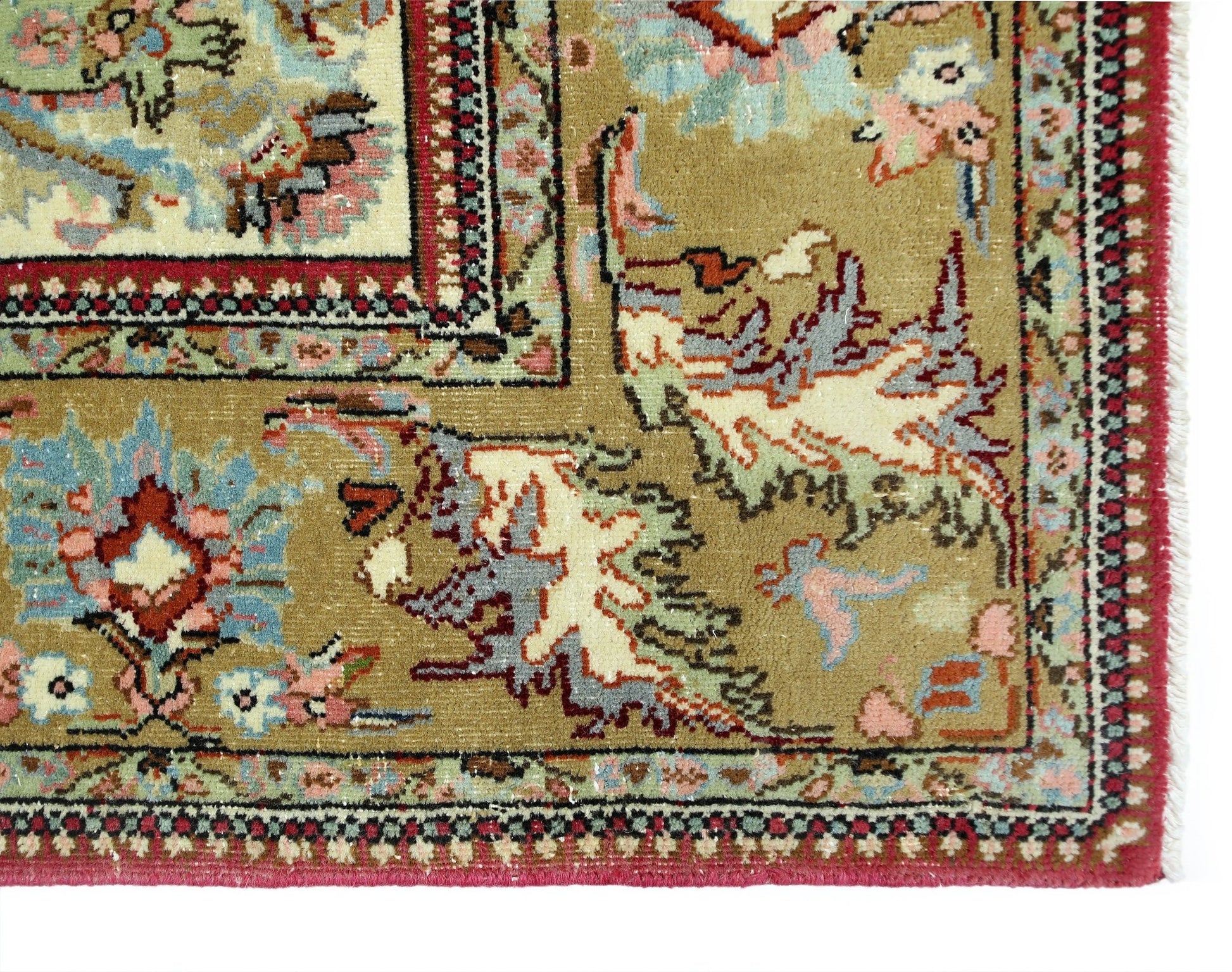 A vintage Persian Bidjar rug featuring intricate floral patterns in muted tones on a tan field.