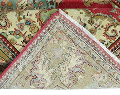 A vintage Persian Bidjar rug with a floral pattern in red, green, and cream tones.