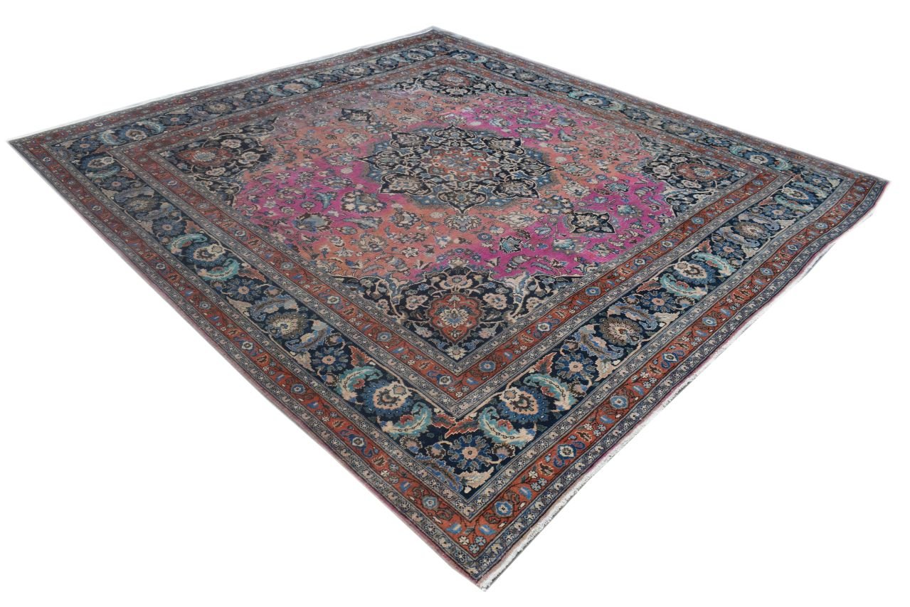 A square vintage Persian Bidjar rug featuring a central medallion on a vibrant pink and blue field.