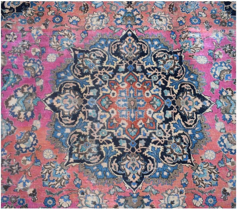 A vintage handmade Persian Bidjar rug featuring a central floral medallion in pink and blue tones.