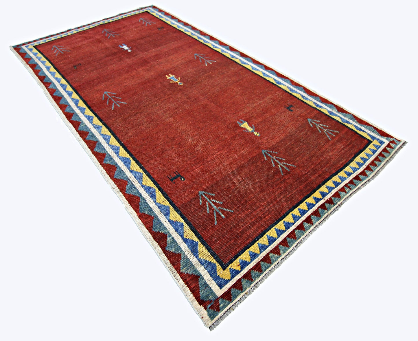 A vintage handmade Persian Shiraz rug featuring a red field with geometric motifs and a patterned border.