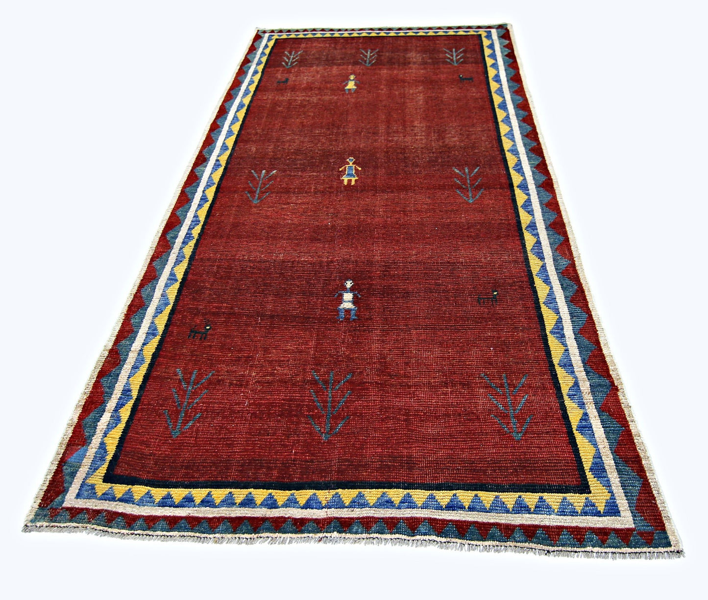 A vintage Persian Shiraz rug featuring a deep red field with stylized figures and geometric borders.