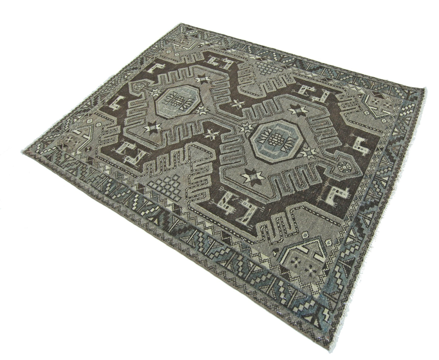 A vintage handmade Persian rug featuring geometric patterns in shades of brown and grey.