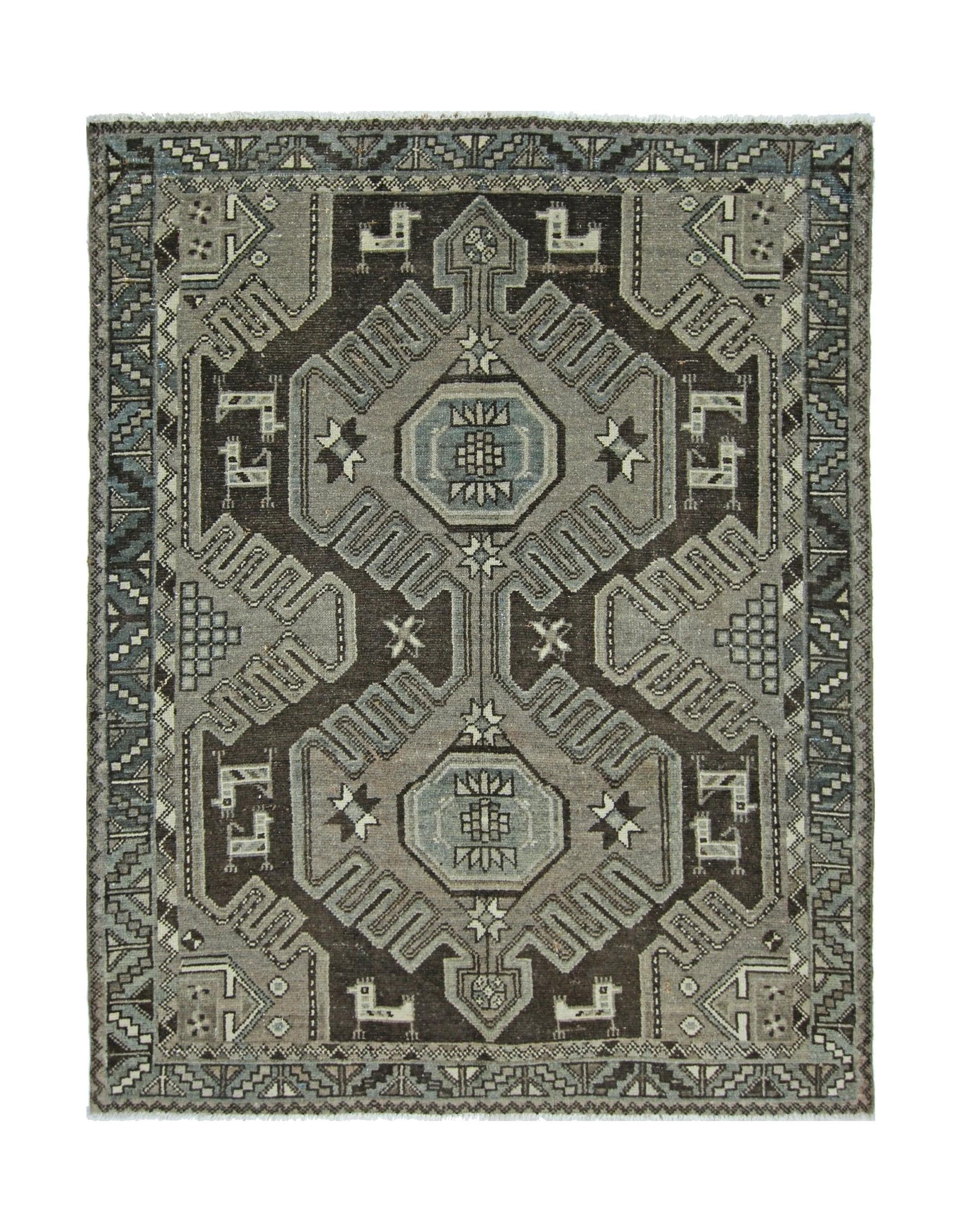 A handmade vintage Persian rug featuring a geometric pattern in shades of grey and brown.