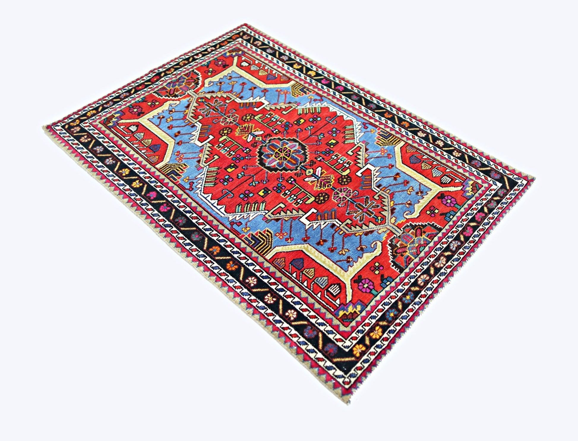 A vintage handmade Persian Hamadan rug featuring a geometric floral pattern in red and blue.