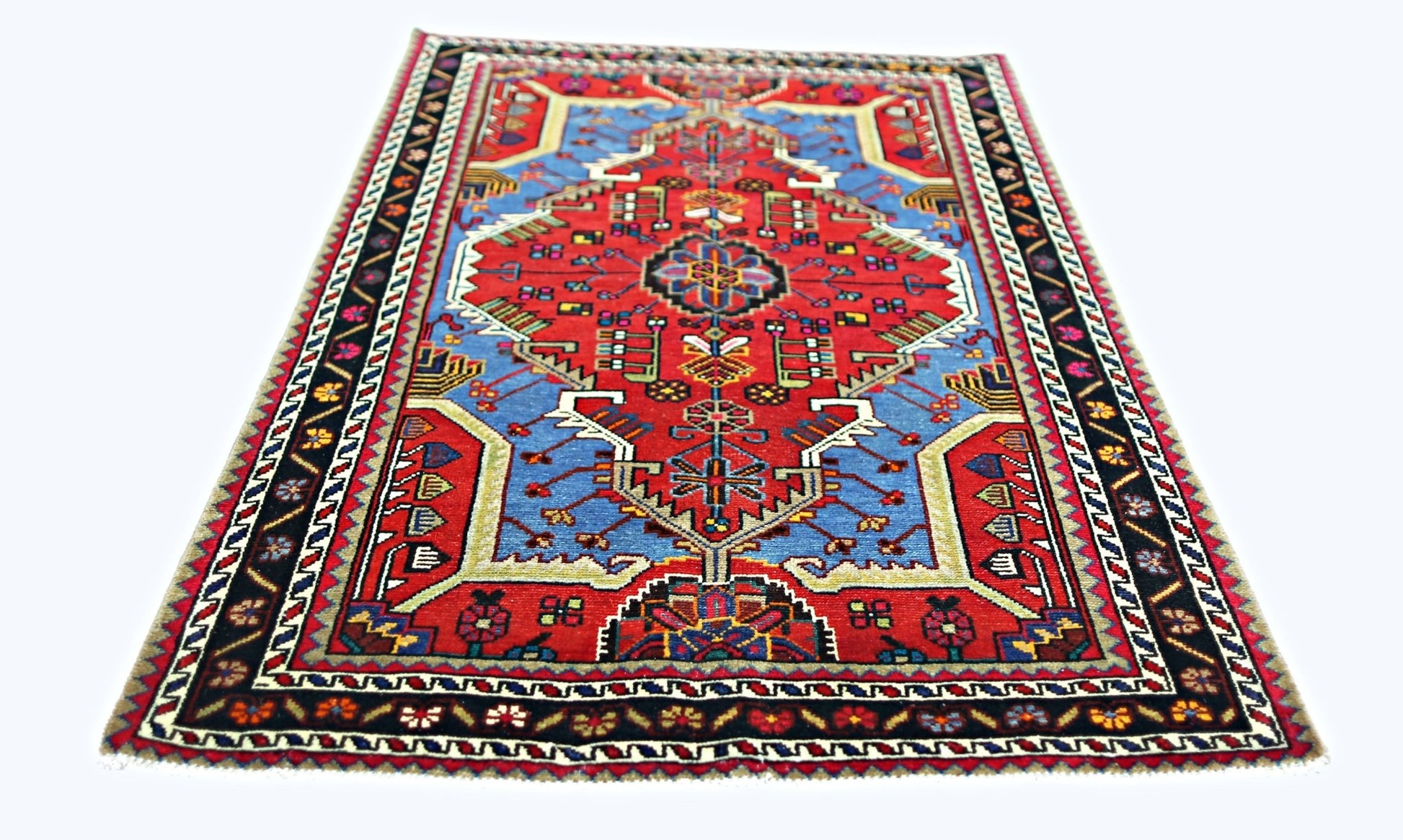 A vintage handmade Persian Hamadan rug featuring a geometric floral pattern in red and blue.