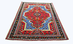 A vintage handmade Persian Hamadan rug featuring a geometric floral pattern in red and blue.