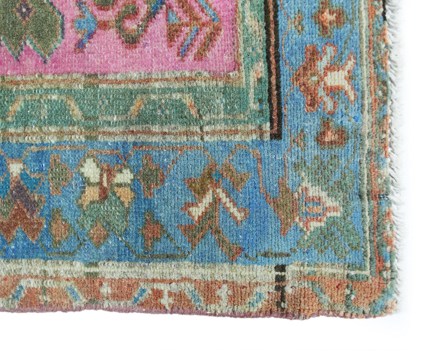 A corner view of a vintage Persian Hamadan rug featuring intricate floral patterns in vibrant hues.