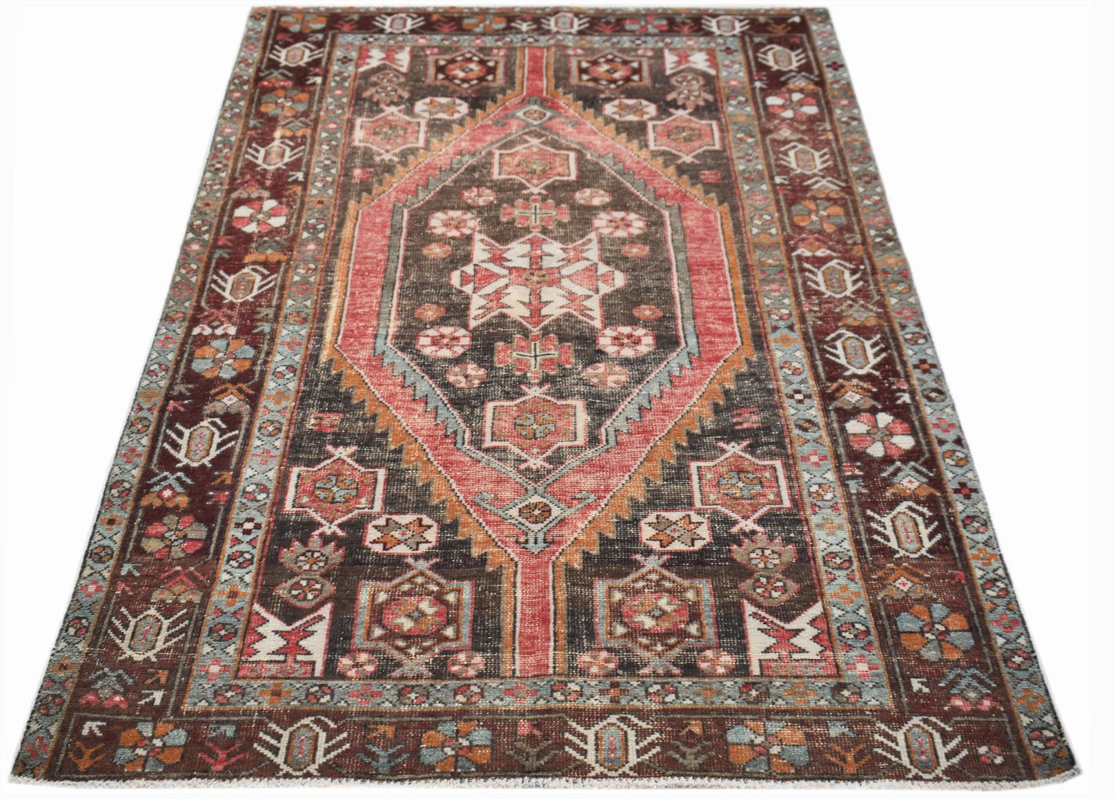 A vintage handwoven Persian Hamadan rug featuring a central diamond medallion in red and brown.
