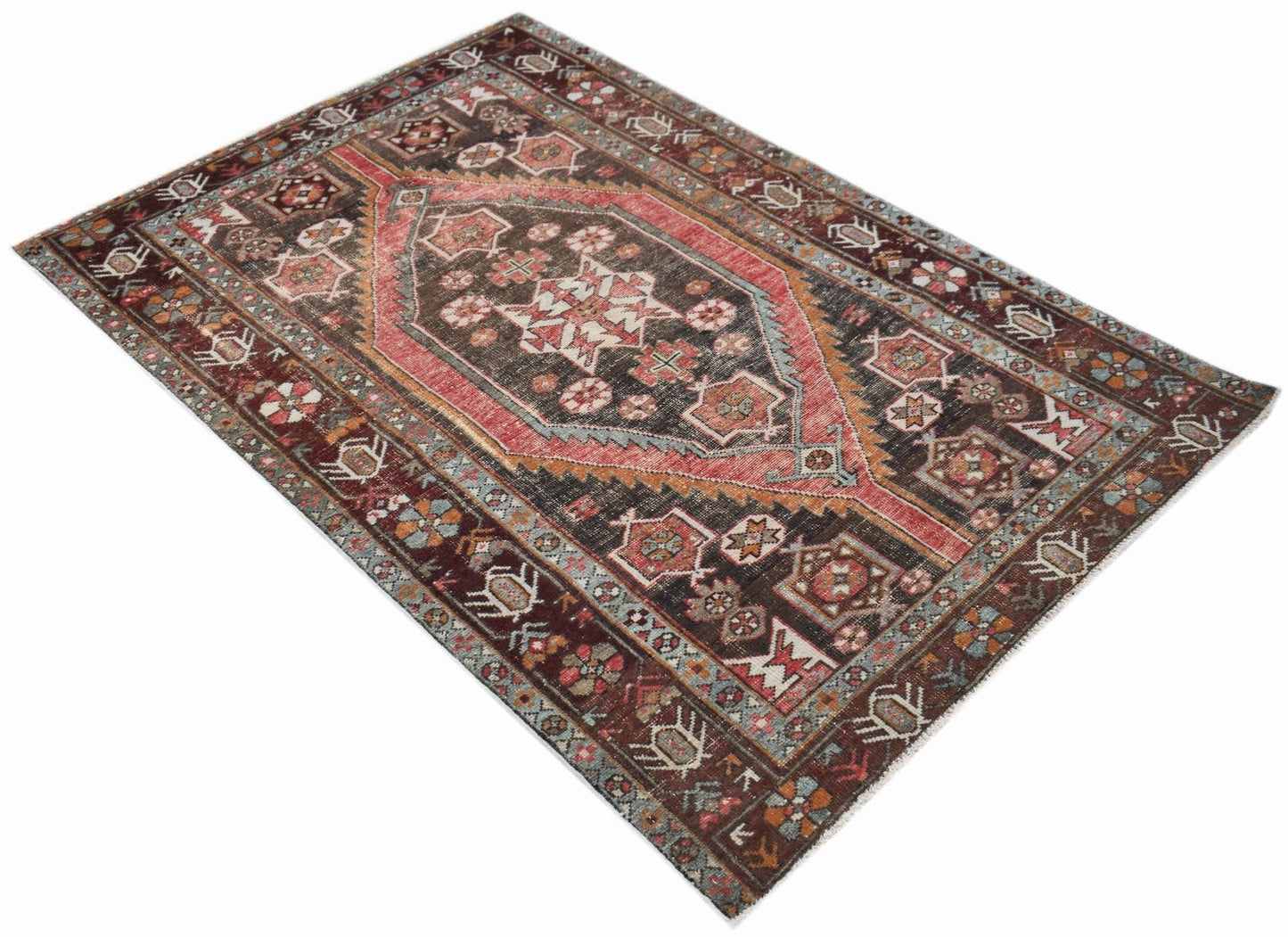 A vintage handwoven Persian Hamadan rug featuring a central medallion in red and dark brown tones.