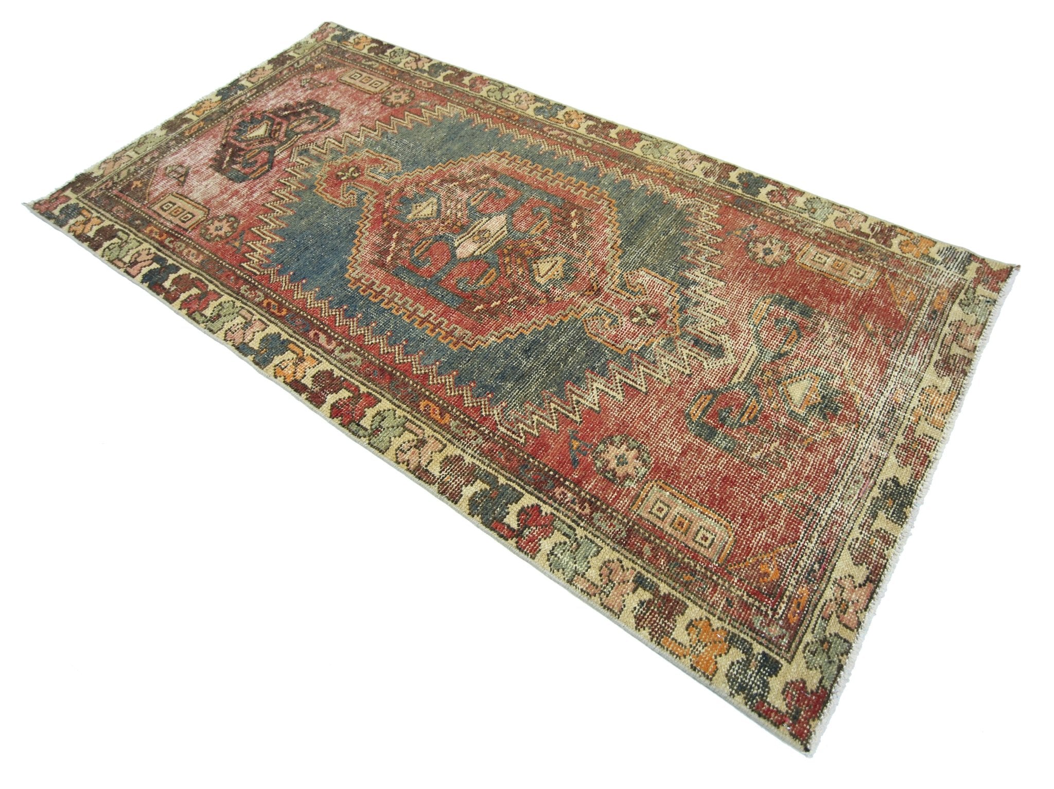 A vintage handmade Persian Hamadan rug featuring a central medallion on a red and blue field.