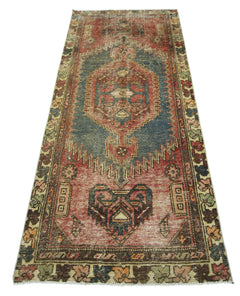 A vintage handmade Persian Hamadan rug featuring a geometric medallion pattern in red and blue.