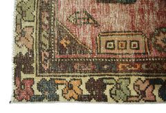 A close-up of a vintage Persian Hamadan rug featuring intricate geometric patterns in warm tones.