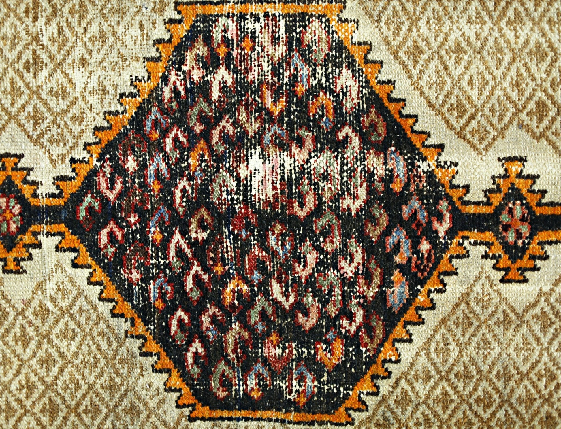 A vintage Persian Hamadan rug featuring a central black diamond medallion with colorful patterns.