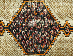 A vintage Persian Hamadan rug featuring a central black diamond medallion with colorful patterns.