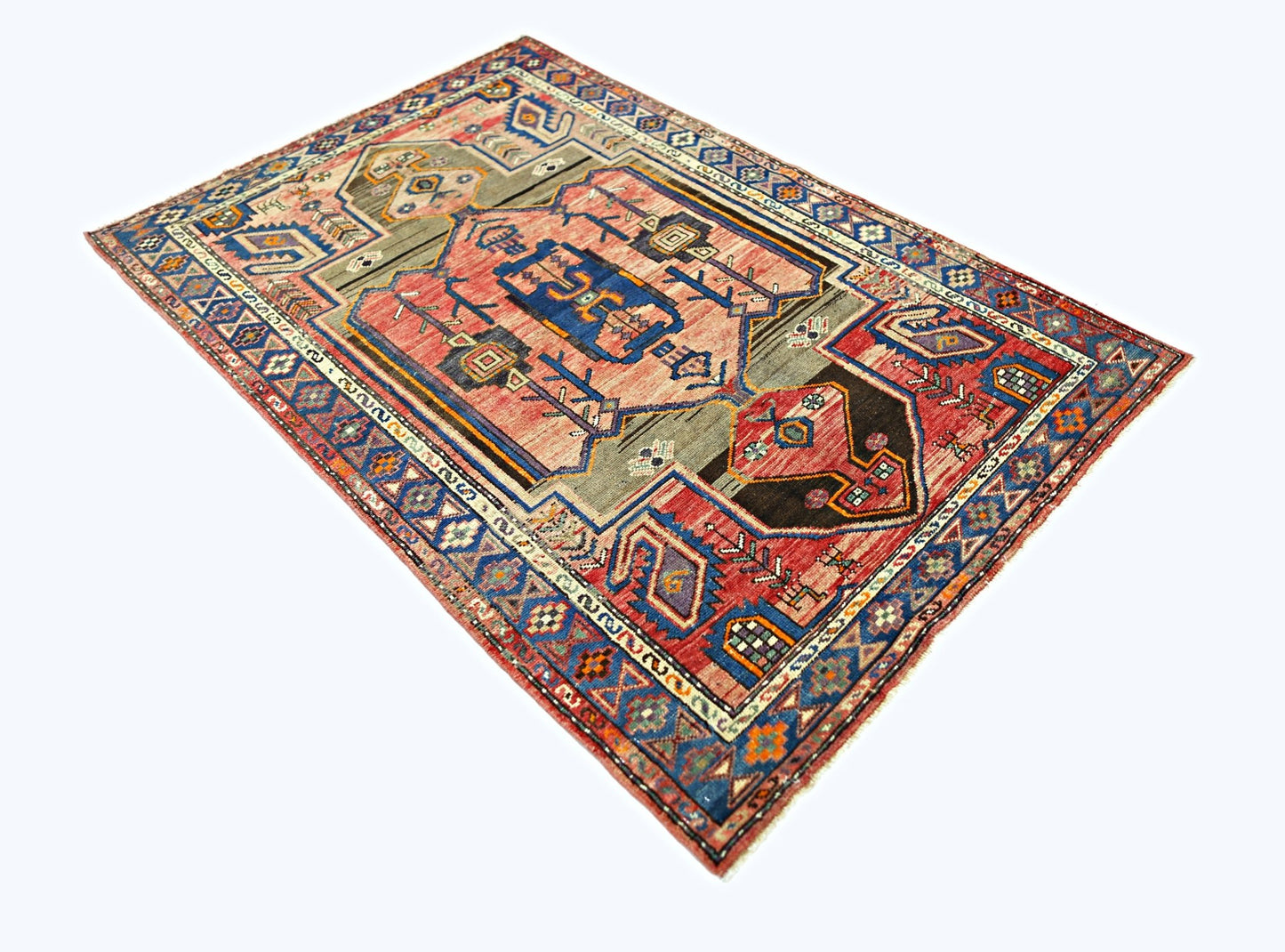 A vintage Persian Hamadan rug featuring a geometric medallion pattern in red, blue, and grey tones.