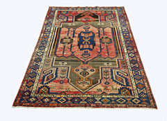 A vintage Persian Hamadan rug featuring a geometric medallion pattern in red, blue, and grey tones.
