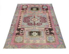 A vintage Persian Hamadan rug featuring geometric patterns in shades of pink, grey, and brown.