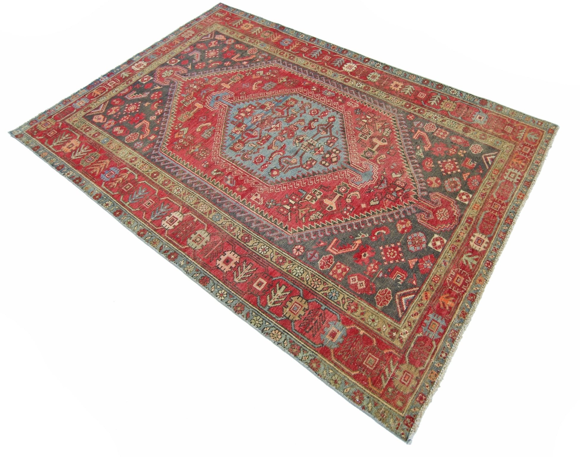A vintage handmade Persian Hamadan rug featuring a central blue medallion on a red field.