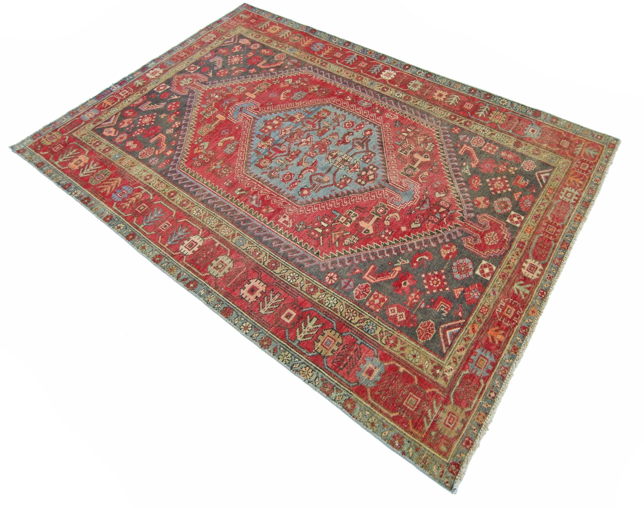 A vintage handmade Persian Hamadan rug featuring a central blue medallion on a red field.