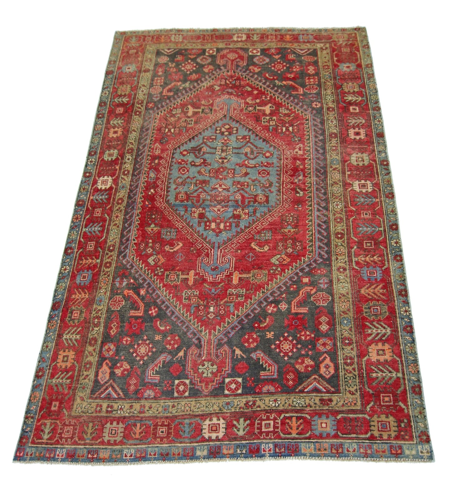 A vintage handmade Persian Hamadan rug featuring a central blue medallion on a red and grey field.