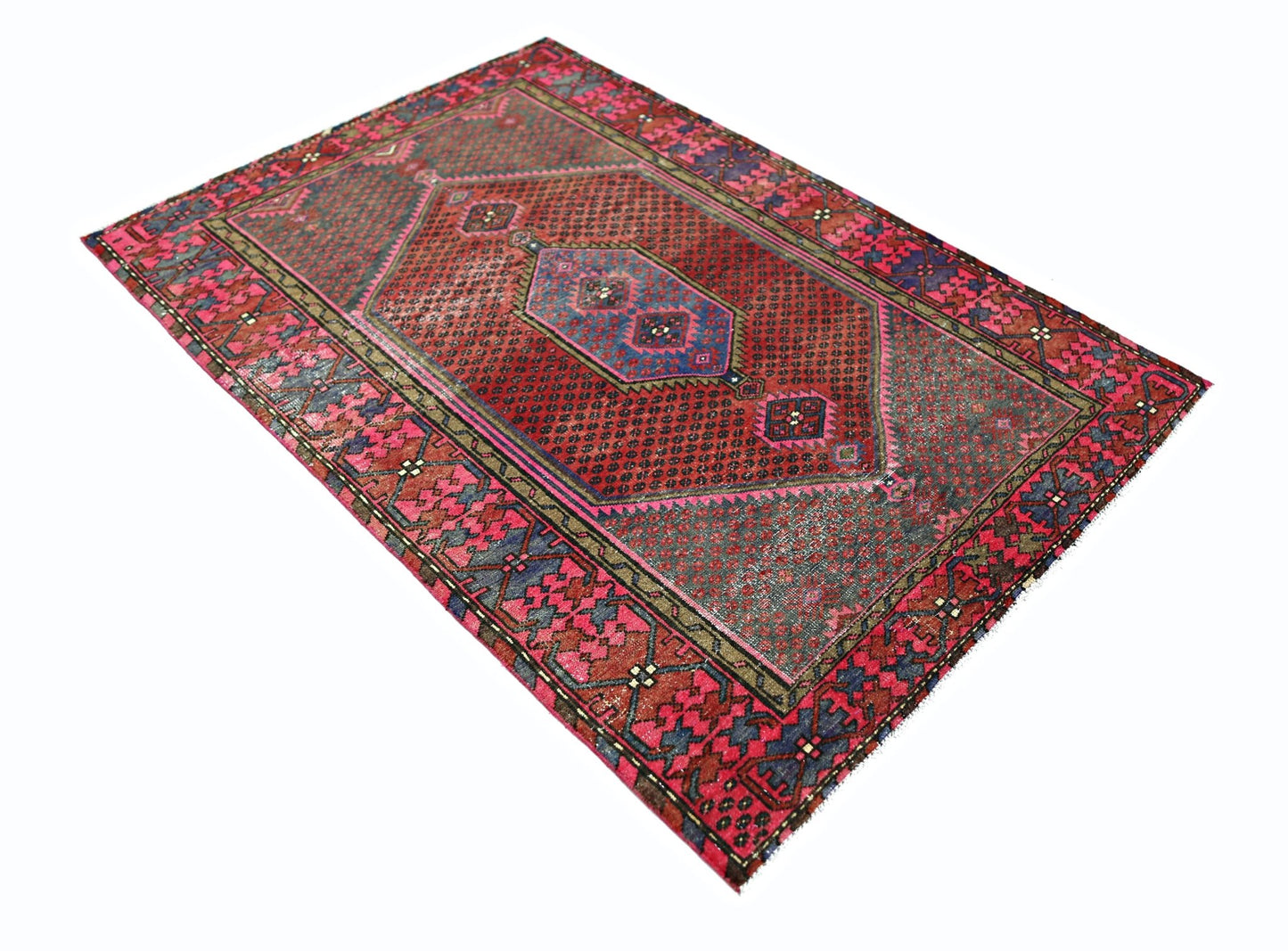 A vintage Persian Hamadan rug featuring a geometric red and blue pattern on a wool pile.