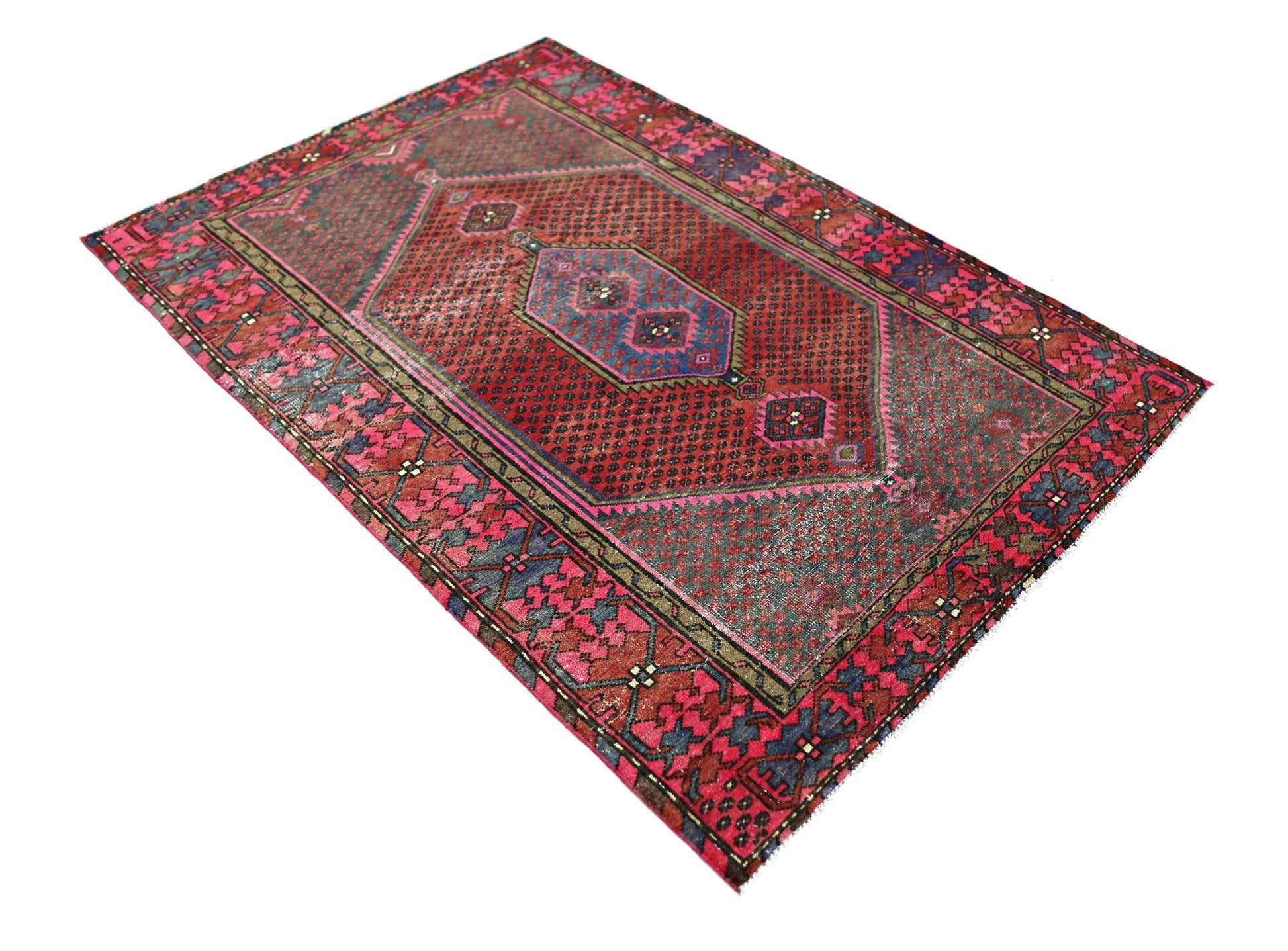 A vintage Persian Hamadan rug featuring a geometric red and blue pattern on a wool pile.