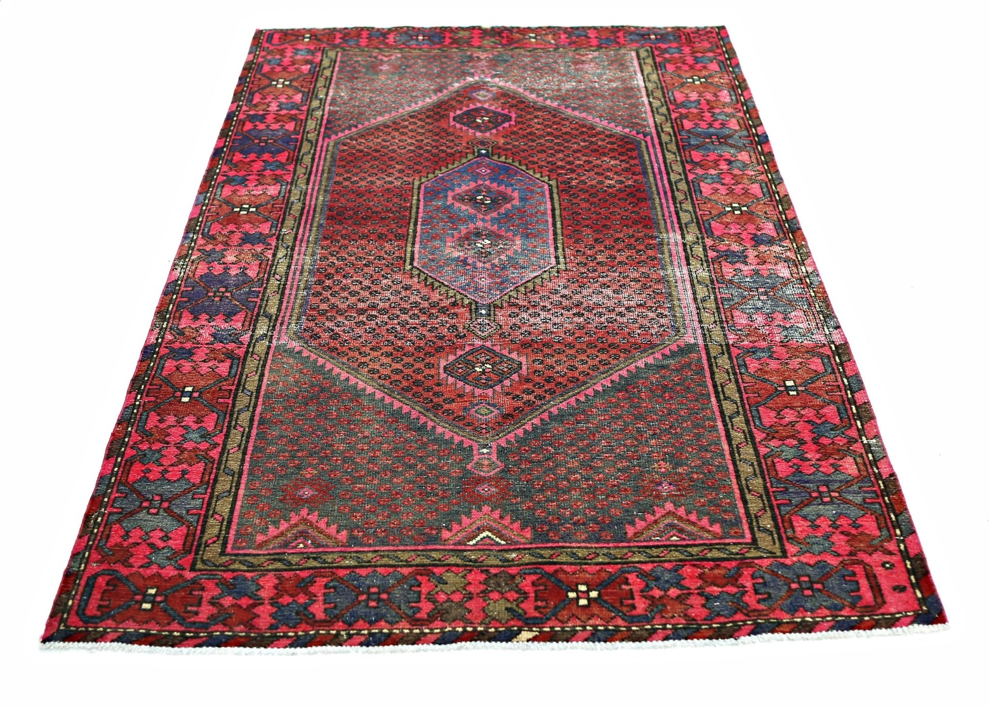 A vintage Persian Hamadan rug featuring a central geometric medallion on a red and blue field.
