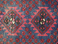 A vintage Persian Hamadan rug featuring a geometric diamond pattern in red, blue, and brown.