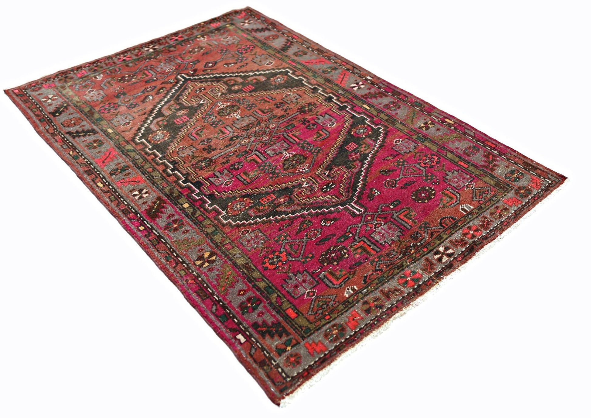 A vintage Persian Hamadan rug featuring a central geometric medallion on a deep red field.