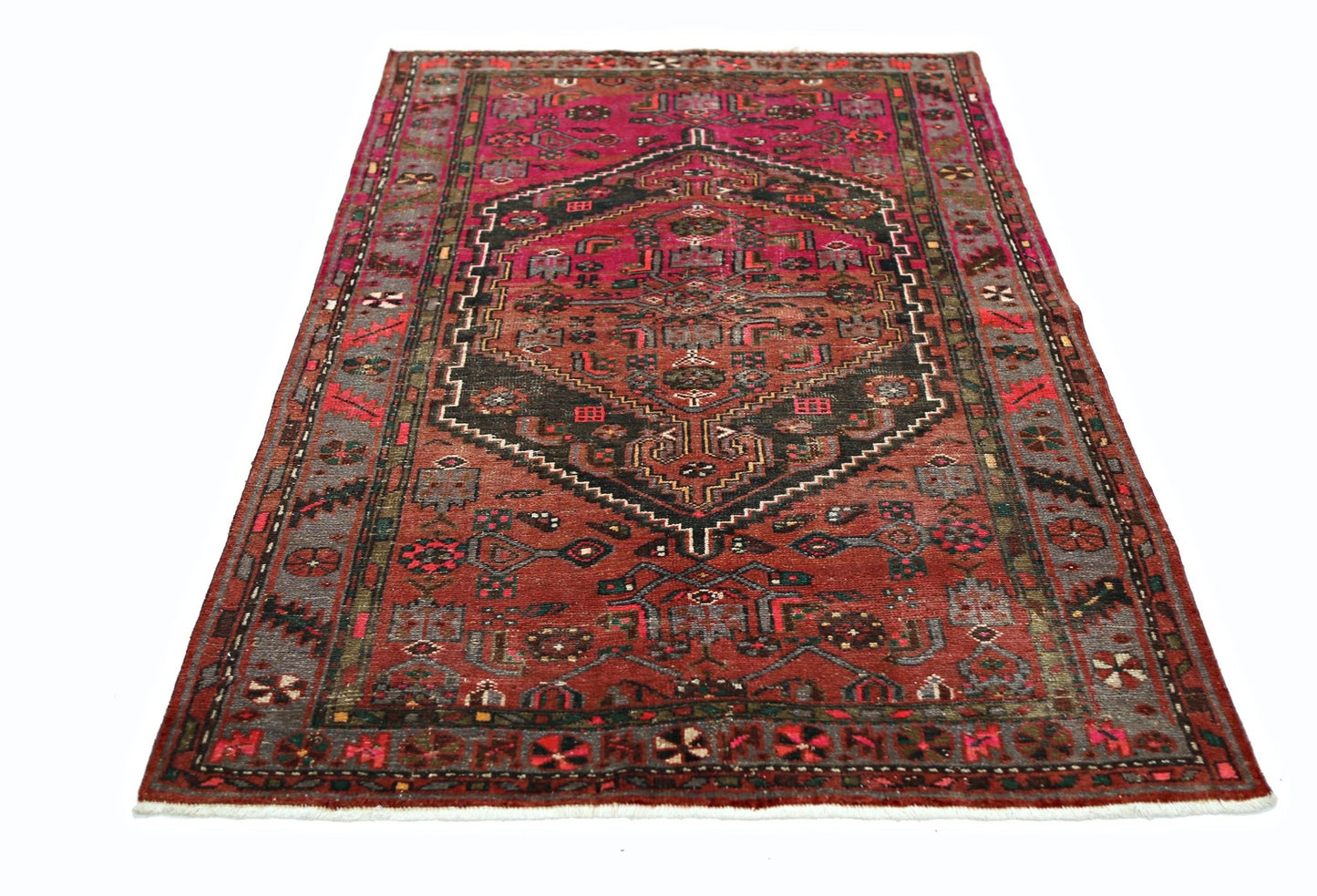 A vintage Persian Hamadan rug featuring a central geometric medallion on a red field.
