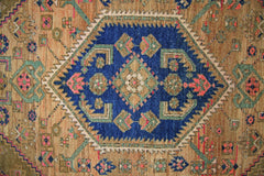 A vintage Persian Hamadan rug featuring a central blue diamond medallion with intricate patterns.
