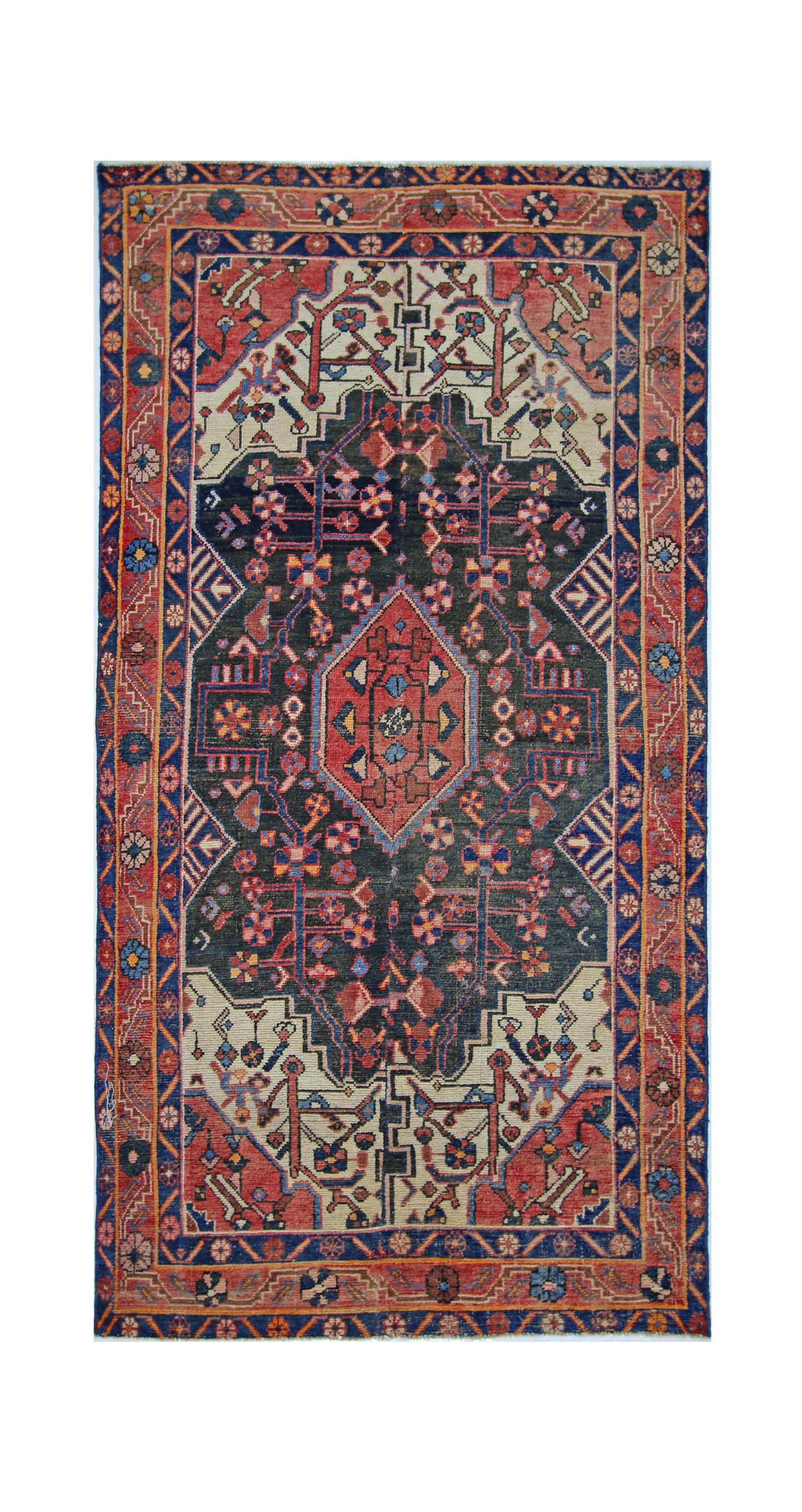 A vintage handmade Persian rug featuring a central diamond medallion on a dark blue field.
