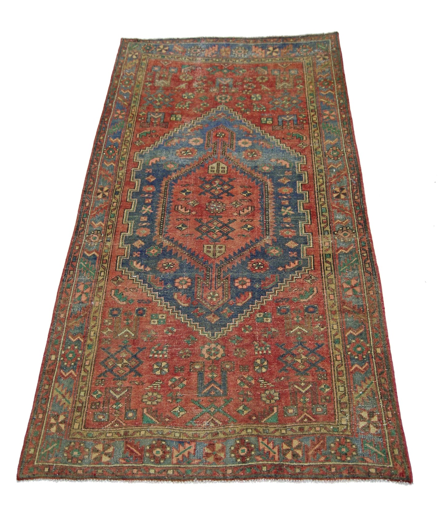 A vintage handmade Persian Hamadan rug featuring a central blue medallion on a red field.